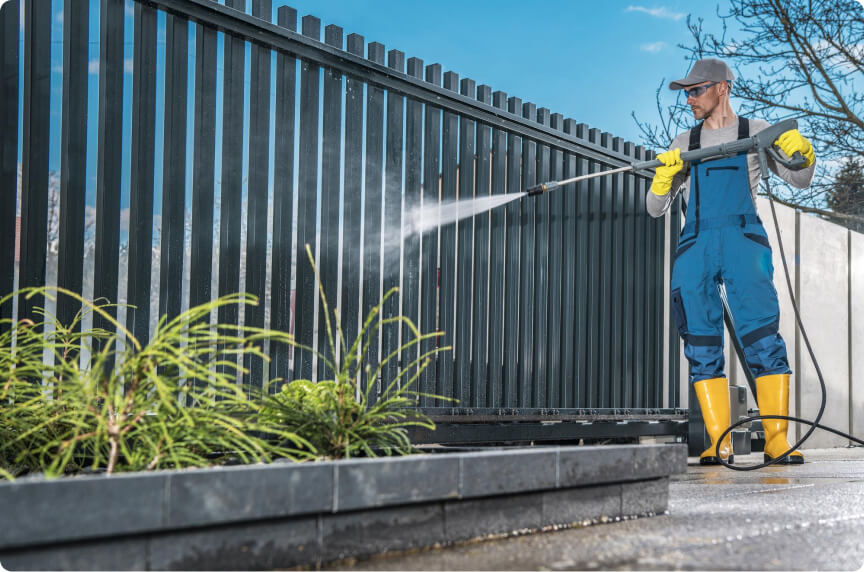 washing his residential driveway gate